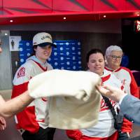 GVSU alum picking up sweatshirt from merch table